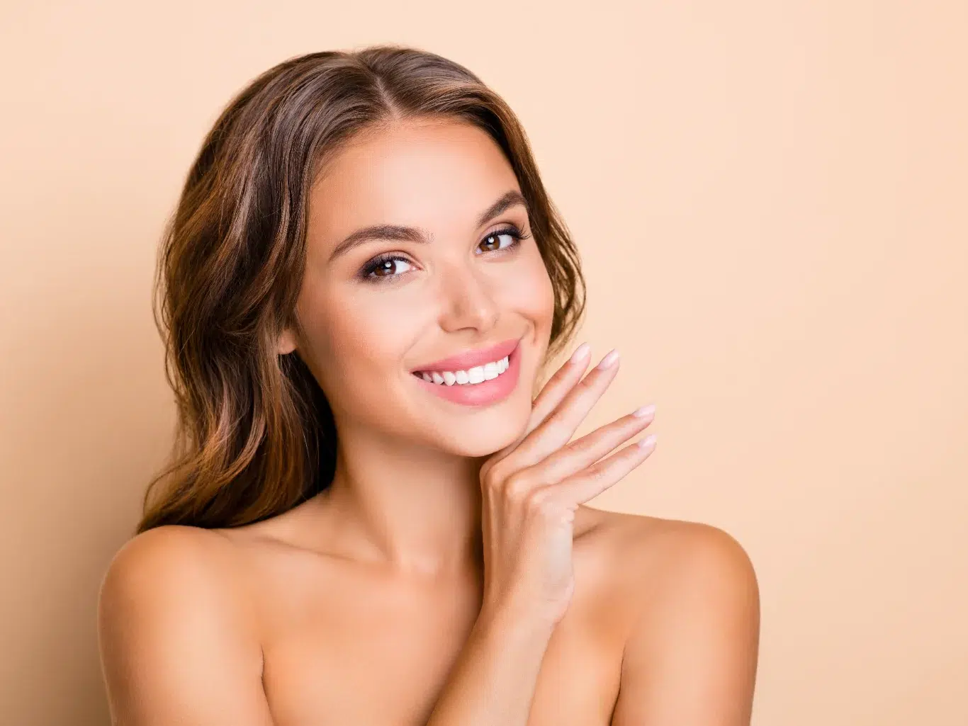 Young Woman with Clean Fresh Skin long hairdo optimistic lady without clothes hand face isolated on pastel beige background